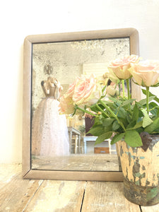 Heavily foxed antique mirror