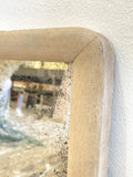 Heavily foxed antique mirror