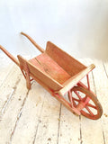 Old pink French child's wheelbarrow