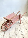 Old pink French child's wheelbarrow