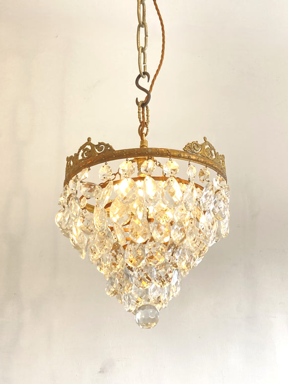 Vintage multi-tier chandelier with crested detail