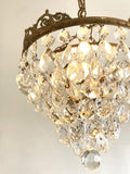 Vintage multi-tier chandelier with crested detail
