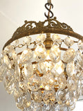 Vintage multi-tier chandelier with crested detail