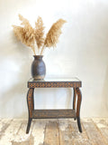 Carved side table with mirrored top