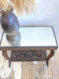Carved side table with mirrored top